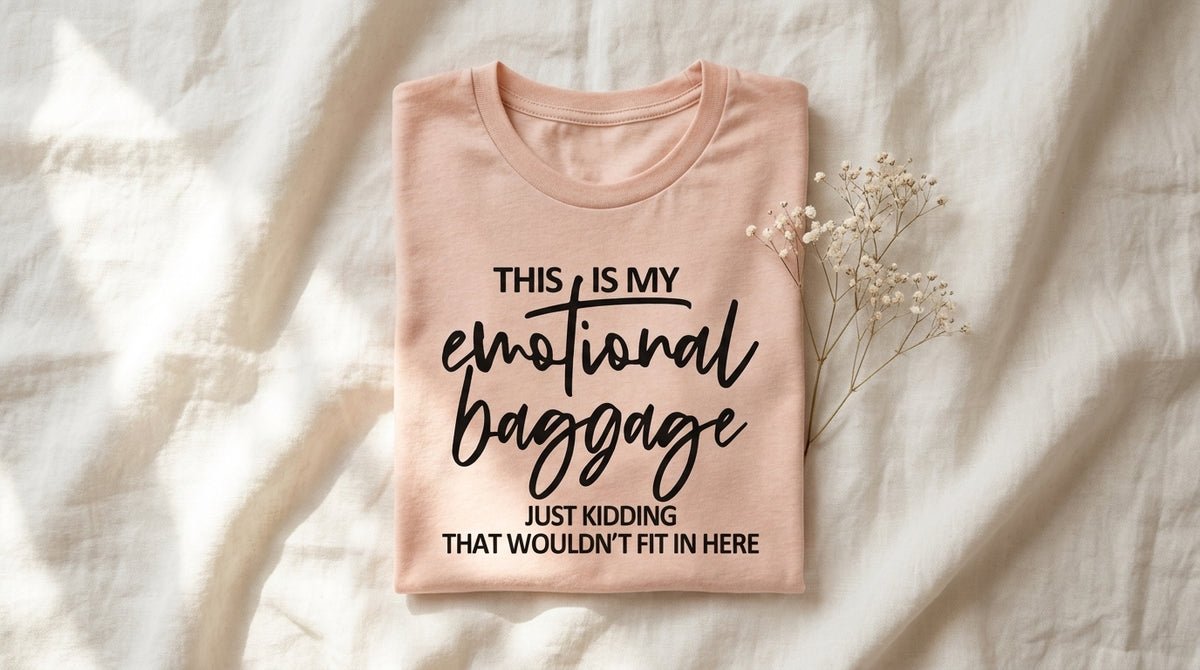 Peach This Is My Emotional Baggage tee folded on rumpled ivory linen with baby's breath – Peachy Sunday Journal UGC hero