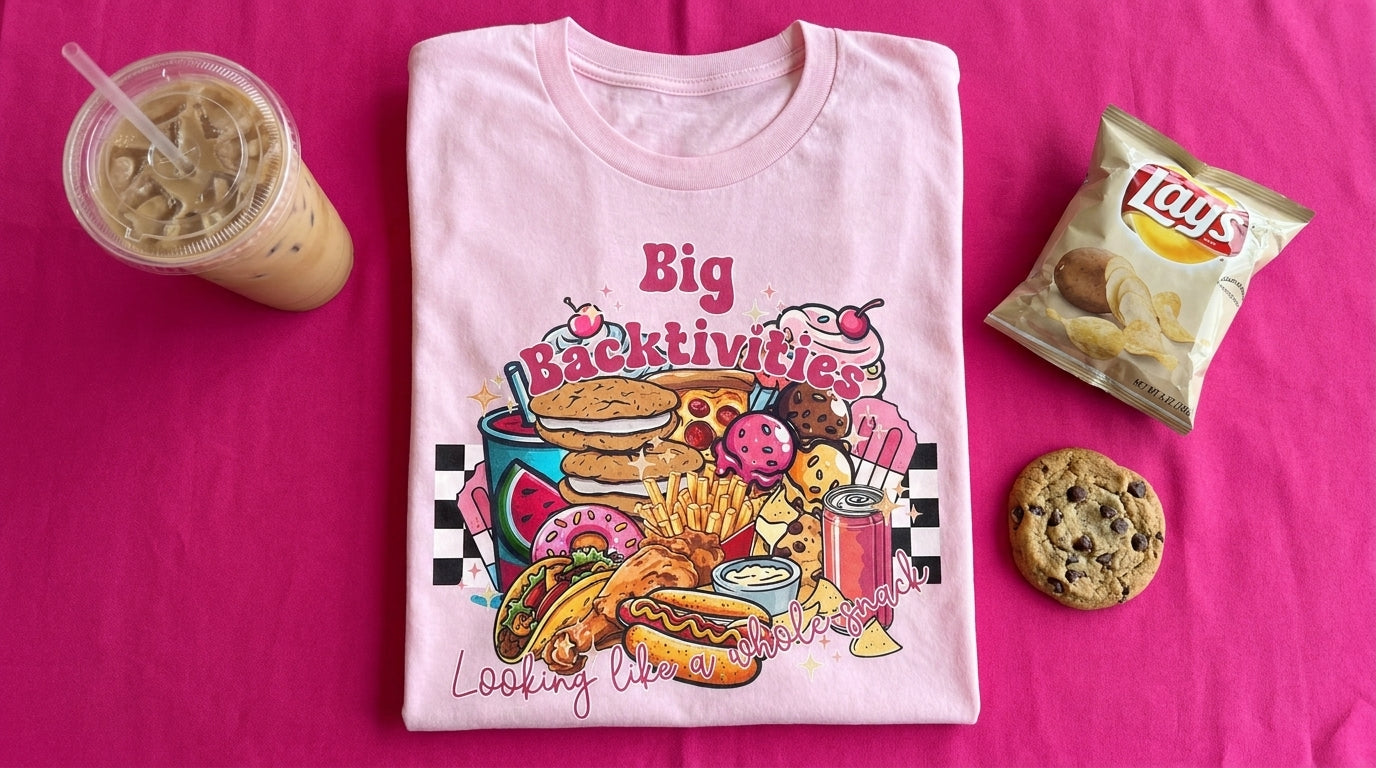 Big Backtivities pink tee on fuchsia linen with iced coffee, cookie, and chips – Peachy Sunday funny foodie shirt