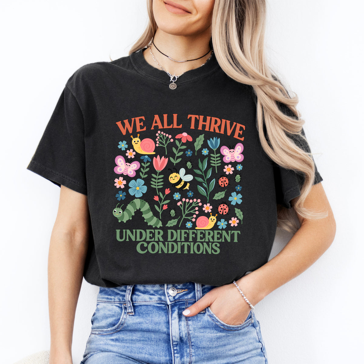 We all thrive under different conditions garden bugs and wildflowers graphic top in black