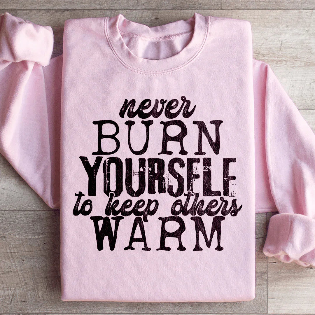 Never Burn Yourself To Keep Others Warm Sweatshirt Light Pink / S Peachy Sunday T-Shirt