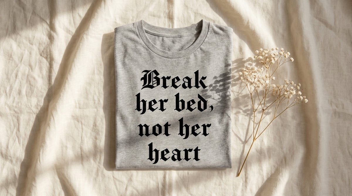 Folded Break her bed, not her heart athletic heather tee on rumpled ivory linen with baby's breath sprig – Peachy Sunday Journal featured hero
