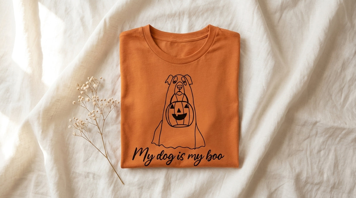 My Dog Is My Boo burnt orange graphic tee folded neatly on rumpled ivory linen with baby's breath sprig – Peachy Sunday Halloween gifts for dog moms