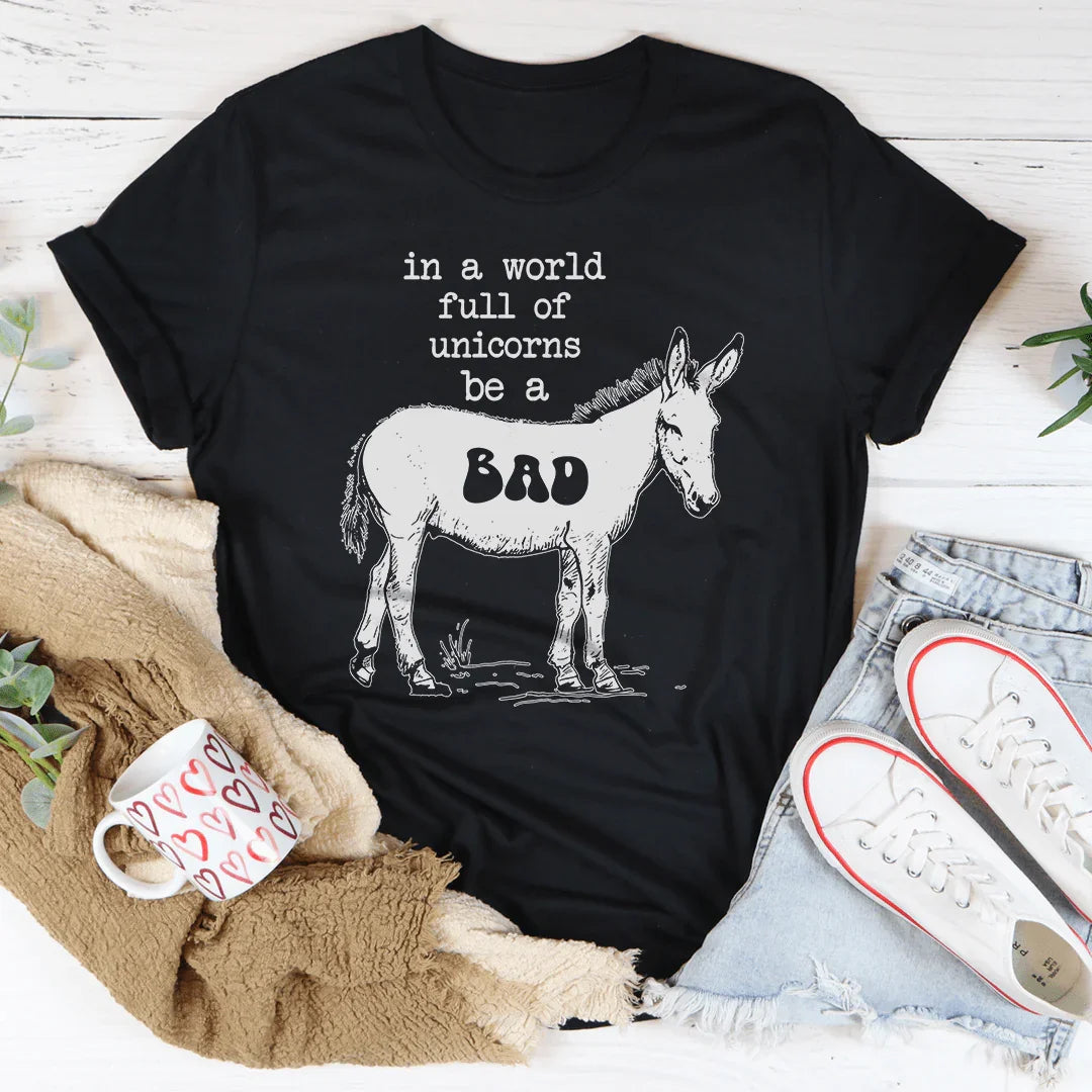 In A World Full Of Unicorns Be A Bad Tee Black Heather / S Peachy Sunday T-Shirt