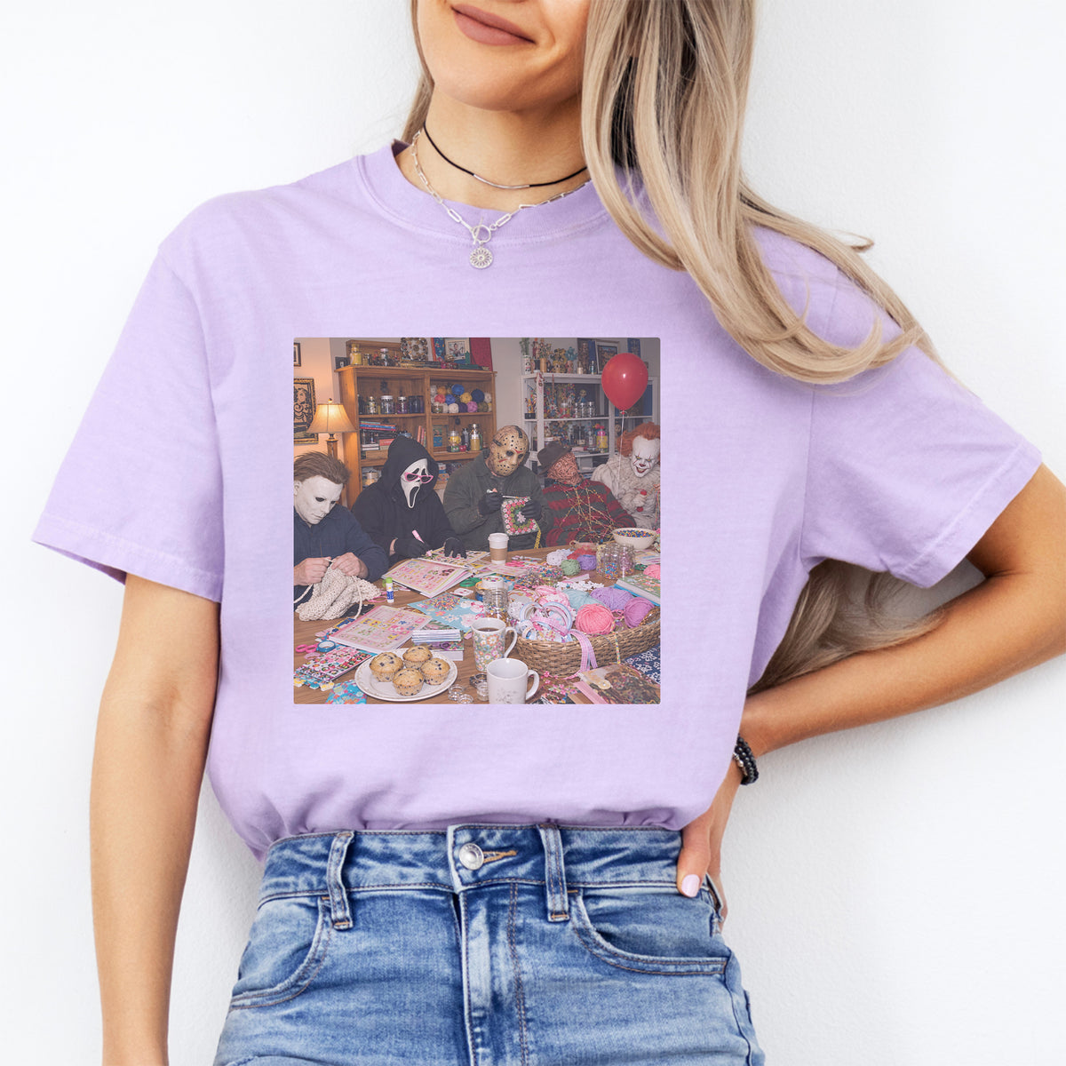 Retro slasher knitting club graphic top showing classic horror movie villains crafting together in orchid lavender