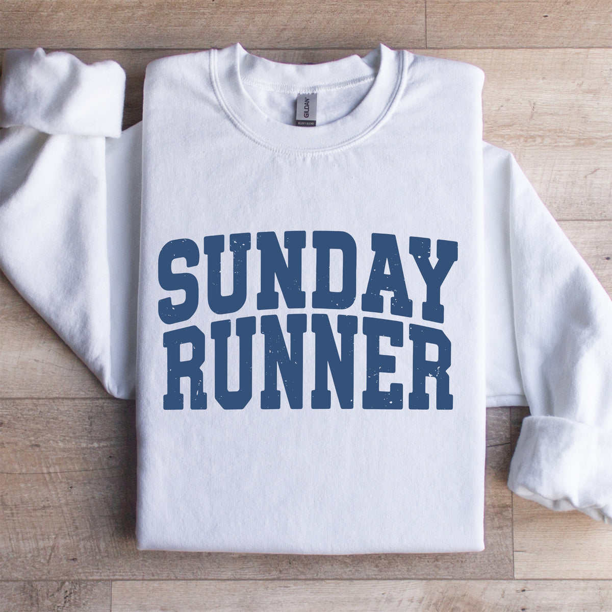 Vintage varsity collegiate crewneck sweatshirt featuring Sunday Runner arch lettering on white fleece pullover