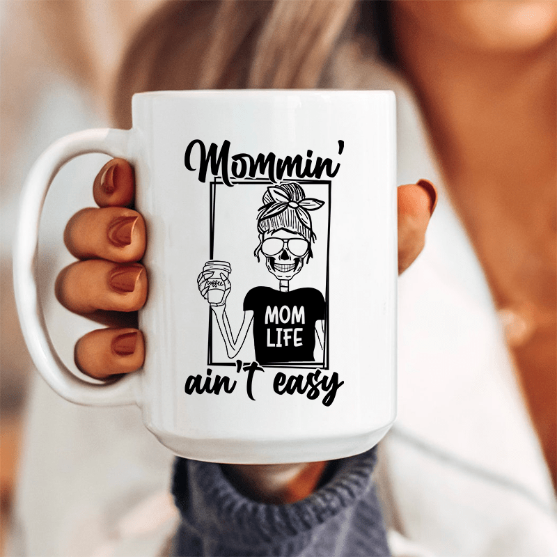 Mommin' Ain't Easy Ceramic Mug 15 oz White / One Size CustomCat Drinkware T-Shirt